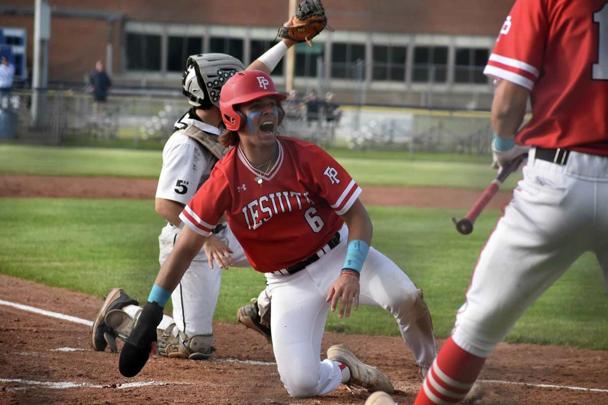Fairfield Prep's Jack Arcamone celebrates after sliding safely into home during the SCC baseball finals between Xavier and Fairfield Prep on Piurek Field, West Have on Thursday, May 26, 2022.