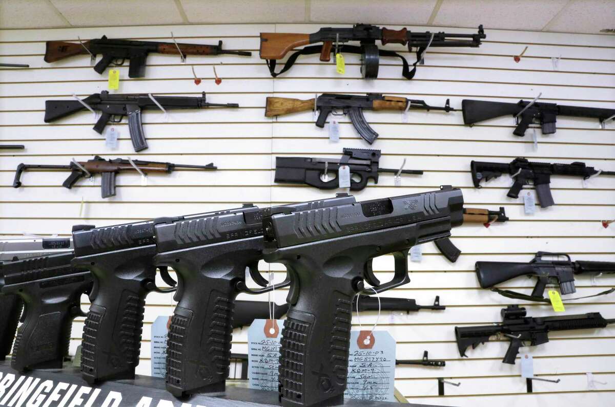 In this Jan. 16, 2013 photo, assault weapons and hand guns are seen for sale at Capitol City Arms Supply in Springfield, Ill. The FBI says the week following the Newtown, Connecticut, shooting massacre saw the greatest number of background checks for firearms sales and permits to carry guns conducted within a one-week period since 1998. The FBI says the second highest week was when President Barack Obama announced sweeping plans to curb gun violence. (AP Photo/Seth Perlman)