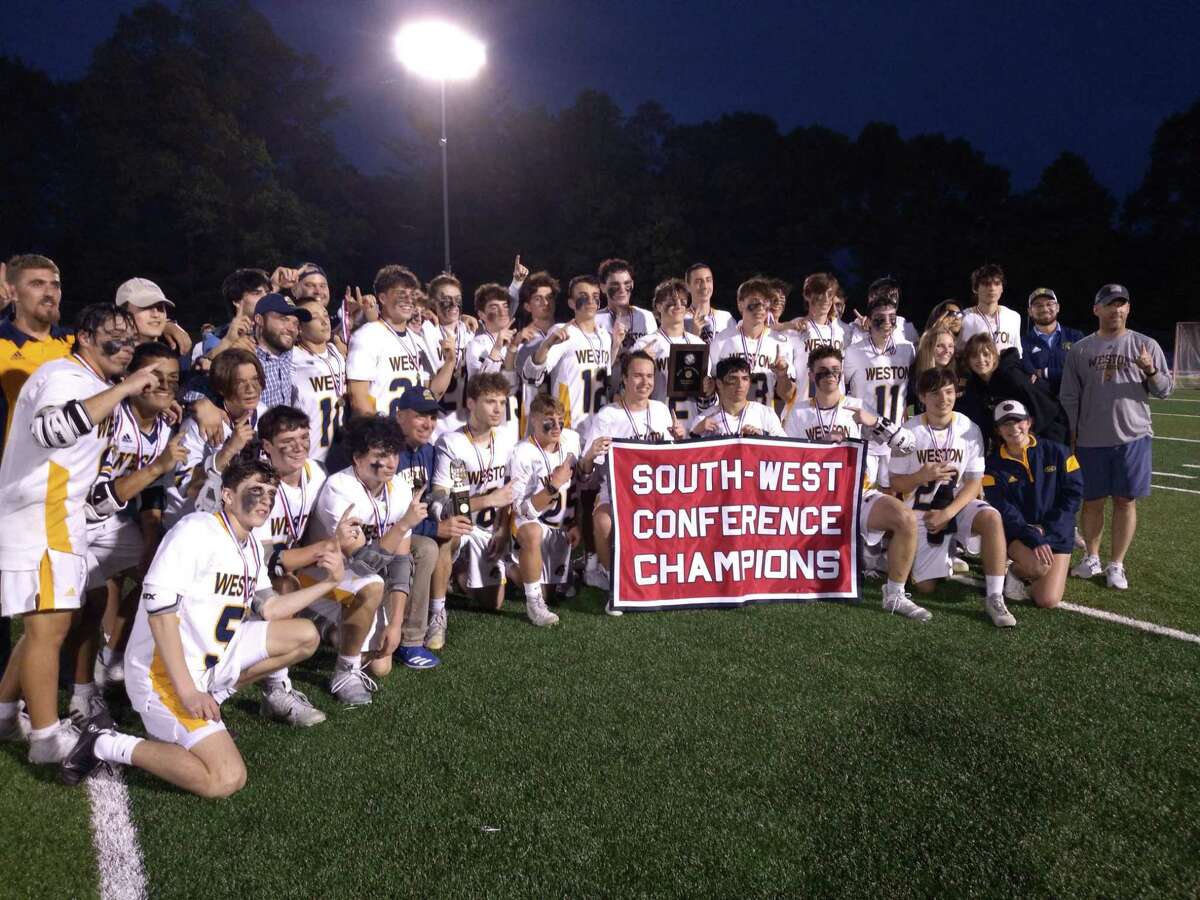 Weston's boys lacrosse team poses with the SWC championship banner after an 11-2 win over New Milford at Blue and Gold Stadium in Newtown, Conn., on May 26, 2022.