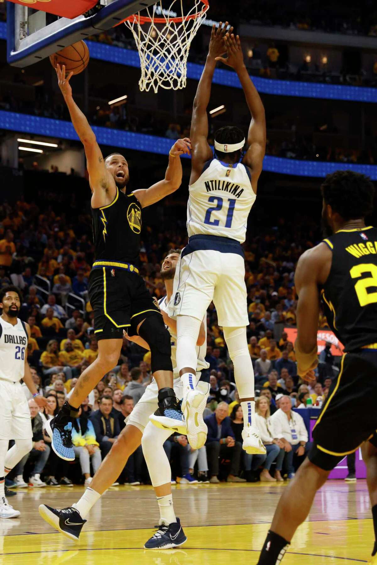 Golden State Warriors' guard Stephen Curry drives towards the basket as Dallas Mavericks’ guard Frank Ntilikina defends during the second quarter in Game 5 of the NBA basketball playoffs Western Conference finals in San Francisco, Calif. Thursday, May 26, 2022.