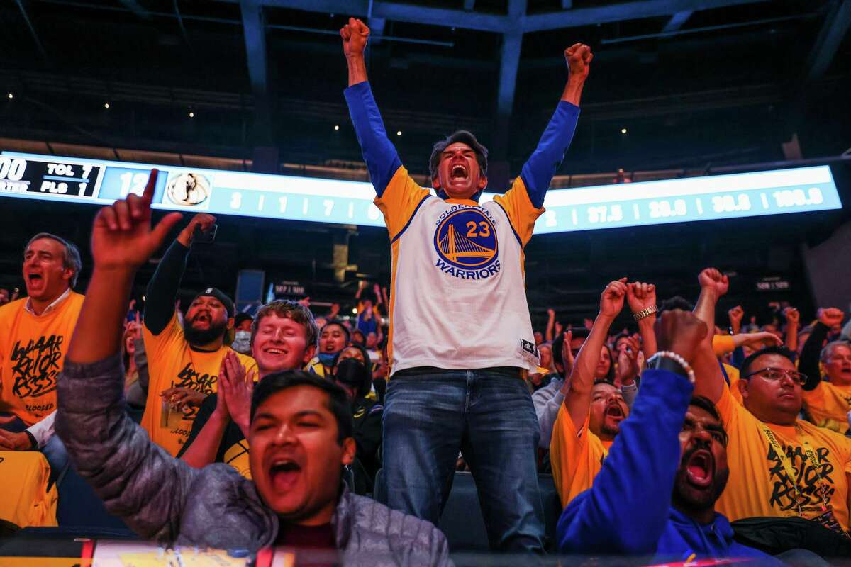 Fan Joe Morford (center) and others cheer during Game 5 of the Western Conference Finals between the Golden State Warriors and the Dallas Mavericks at Chase Stadium on Thursday, May 26, 2022 in San Francisco, California. Resale ticket prices for the NBA Finals beginning Thursday at Chase Center, were averaging $3,526 per seat, higher than any of the team’s five previous appearances in the Finals.