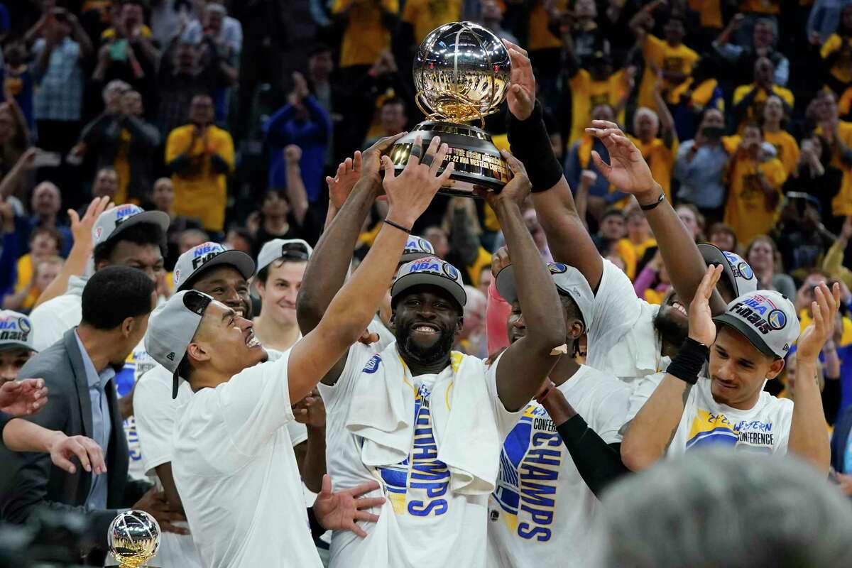 Golden State Warriors celebrate with the conference trophy after defeating the Dallas Mavericks in Game 5 of the NBA basketball playoffs Western Conference finals in San Francisco, Thursday, May 26, 2022.