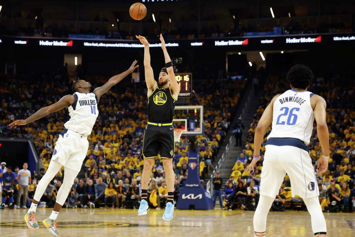 Golden State Warriors' guard Klay Thompson shoots a three-pointer as Dallas Mavericks’ forward Dorian Finney-Smith defends during the second quarter in Game 5 of the NBA basketball playoffs Western Conference finals in San Francisco, Calif. Thursday, May 26, 2022.