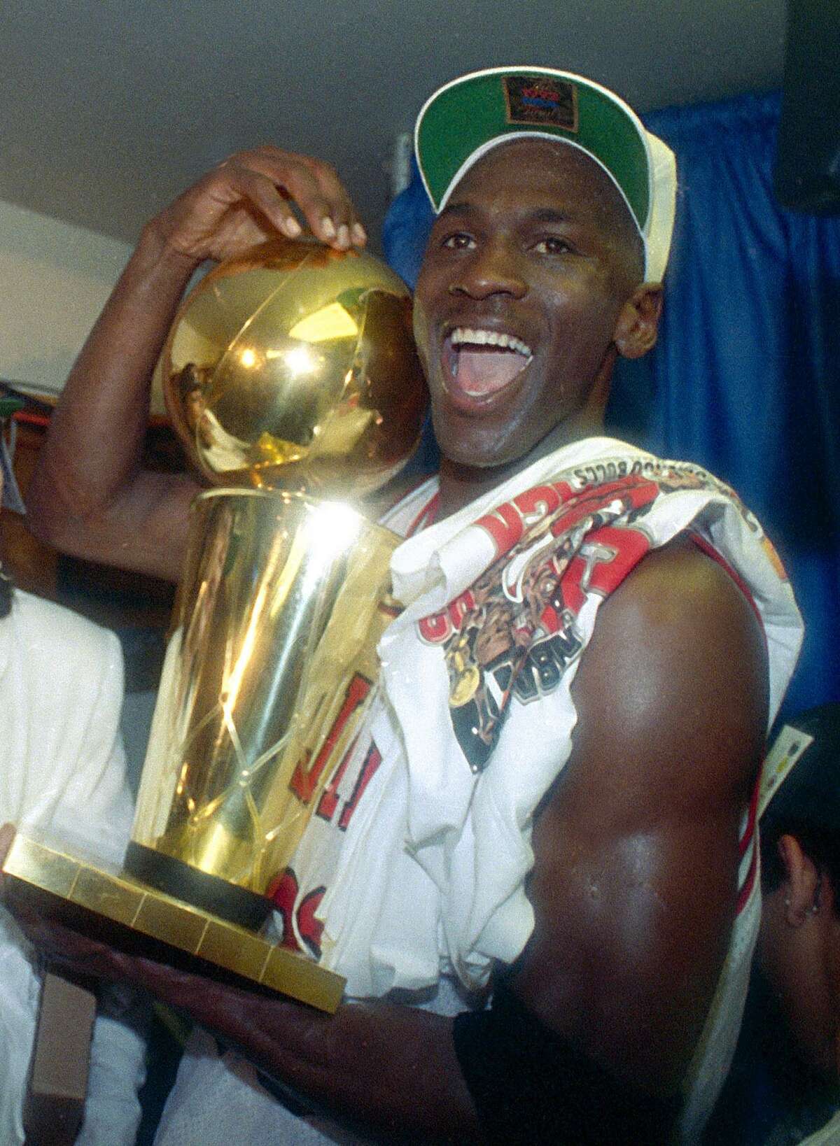 FILE -- This is a june 14, 1992 file photo showing Chicago Bulls' Michael Jordan celebrating with the NBA trophy after the Bulls beat the Portland Trail Blazers 97-93 in Chicago, to win their second straight NBA title. On Friday, Sept. 11, 2009, Jordan will be enshrined at the Basketball Hall of Fame. (AP Photo/Mark Duncan, File)