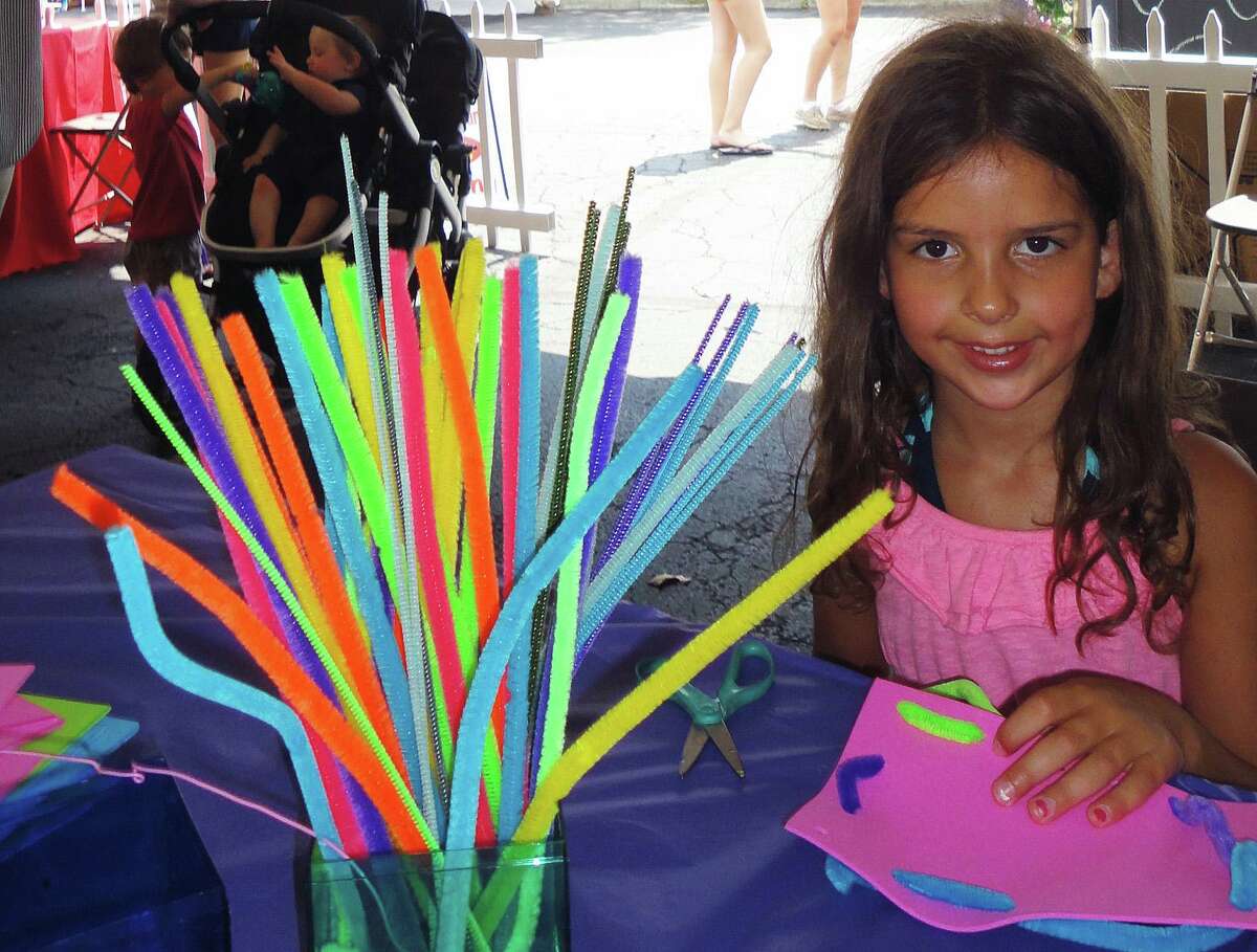 Lila Greifenberger, 5, of Westport, created artwork using foam sheets and colorful pipe cleaners in a designated creative area called the Whimsical World of WAC (Westport Arts Center) on Saturday at the Westport Fine Arts Festival.