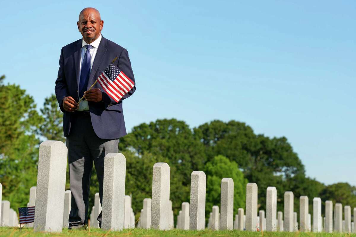 Dwight Ben, 60, who served in the U.S. Navy for 20 years as an electrician’s mate, poses for a portrait in the Houston National Cemetery on Thursday, May 26, 2022 in Houston. Ben says working at the Houston National Cemetery for veterans is an honor, because he gets to take his comrades to their final resting place.