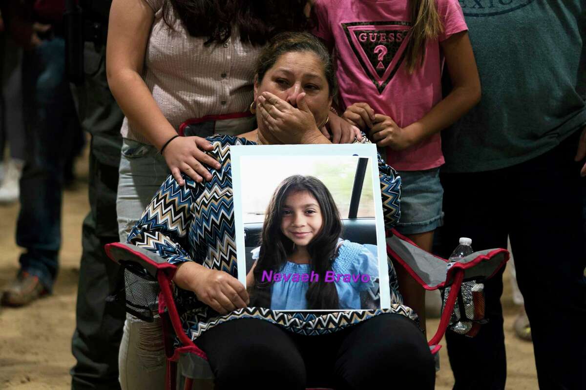 Esmeralda Bravo, 63, sheds tears while holding a photo of her granddaughter, Nevaeh, one of the Robb Elementary School shooting victims, during a prayer vigil in Uvalde, Texas, May 25, 2022. The children who survived the attack, which killed 19 schoolchildren and two teachers, described a festive, end-of-the-school-year day that quickly turned to terror.