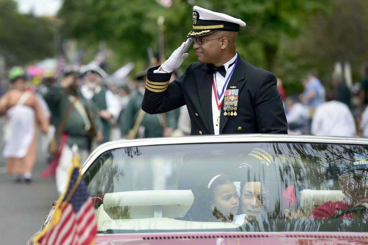 Grand Marshal Michael Thomas, a U.S. Navy Commander, salutes during the Milford Memorial Day Parade.