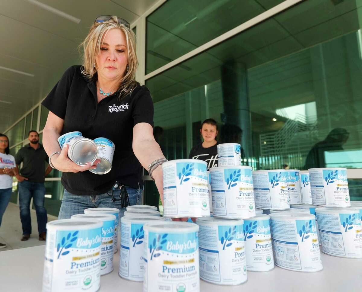 Debbie Glenn helps load toddler formula for a nonprofit as volunteers distribute 180 cans of formula at Woodforest National Bank in downtown Conroe, Thursday, May 26, 2022. According to the American Academy of Pediatrics, toddler formula is intended for kids who are one year of age or older. Health professionals advise parents to consult their pediatrician if temporarily supplementing toddler for infant formula is appropriate for their child.
