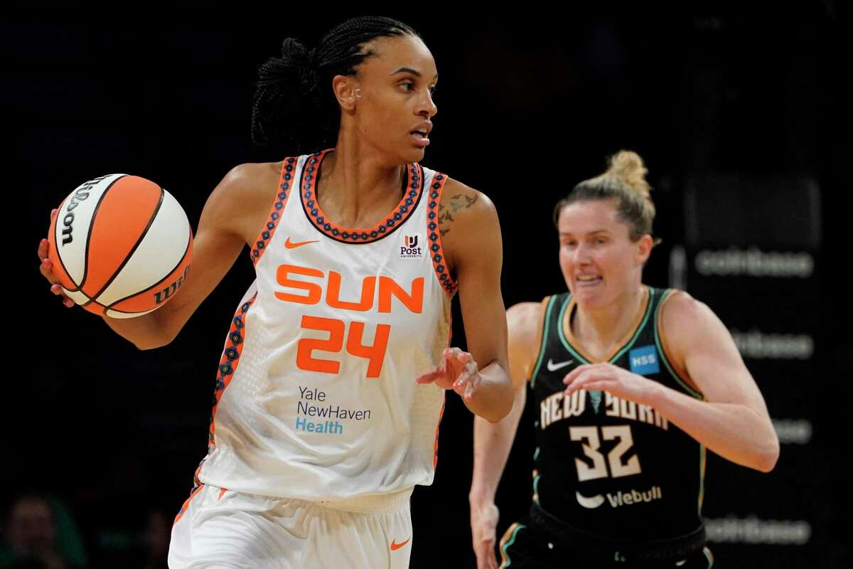 Connecticut Sun forward DeWanna Bonner (24) looks to pass with New York Liberty guard Sami Whitcomb (32) in the first half during a WNBA basketball game, Tuesday, May 17, 2022, in New York. (AP Photo/John Minchillo)
