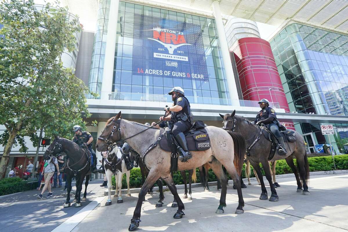Mounted Houston police officers patrol outside of the National Rifle Association Annual Meeting at the George R. Brown Convention Center, on May 27, 2022, in Houston, Texas. - America's powerful National Rifle Association kicked off a major convention in Houston Friday, days after the horrific massacre of children at a Texas elementary school, but a string of high-profile no-shows underscored deep unease at the timing of the gun lobby event. (Photo by CÃ©cile Clocheret / AFP) (Photo by CECILE CLOCHERET/AFP via Getty Images)