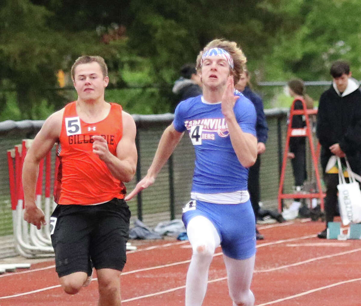 Carlinville's Ethen Siglock (right), shown running with Gillespie's Ronnie Monke in the 100 at the SCC Meet earlier this season, ran in four events Thursday at the Class 1A state meet prelims and advanced to Saturday's finals in the 200 meters.