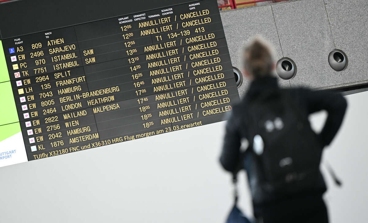 A display board shows cancelled flights at the airport.