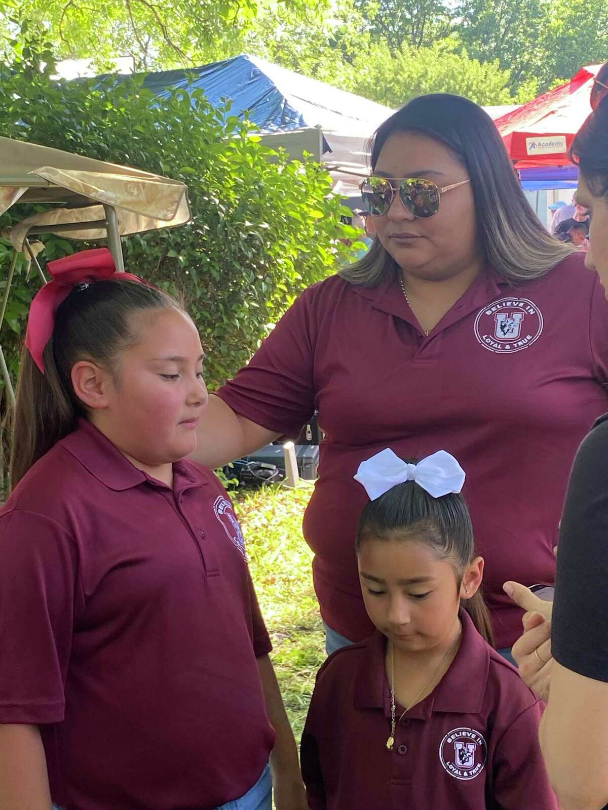Adalynn Garza, age 9, with her mother, Monique Rodriguez, and younger sister, Kinsley. “I feel scared,” she said. “Because what happened in this grade will happen again.”
