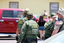 Law enforcement officials evacuate students and staff from Robb Elementary School after a gunman entered a classroom and began shooting on Tuesday, May 24, 2022.