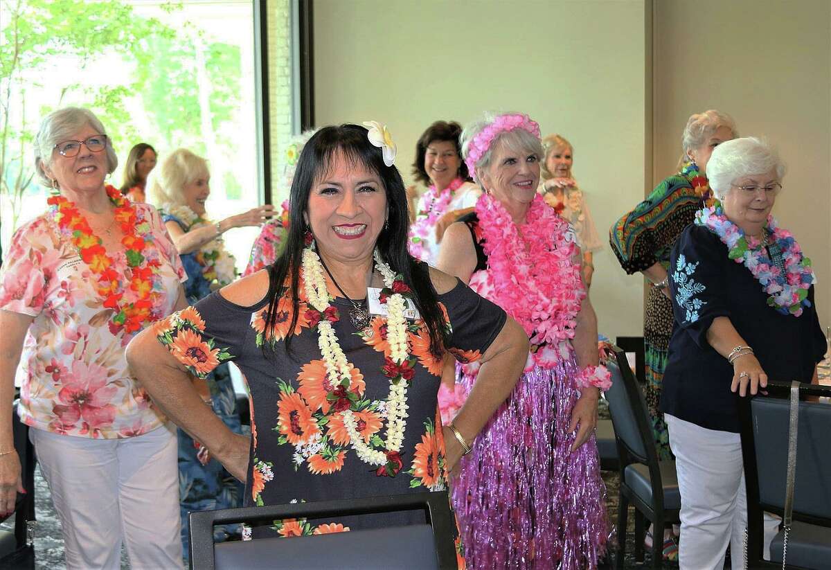 Members of the Hi Neighbor Kingwood organization let their hair down at the most recent Hawaaian-themed luncheon learning how to hula. The May meeting saw the installation of new officers and was the last one while they take a summer hiatus. They will return in September.