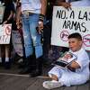 Children hold signs and photos of mass shooting victims, including a photo of Amerie Jo Garza, 10, who was fatally shot at the Uvalde. The children are part of a protest rally against the presence of an NRA convention at the George R. Brown Convention Center in Houston, Friday, May 27, 2022.