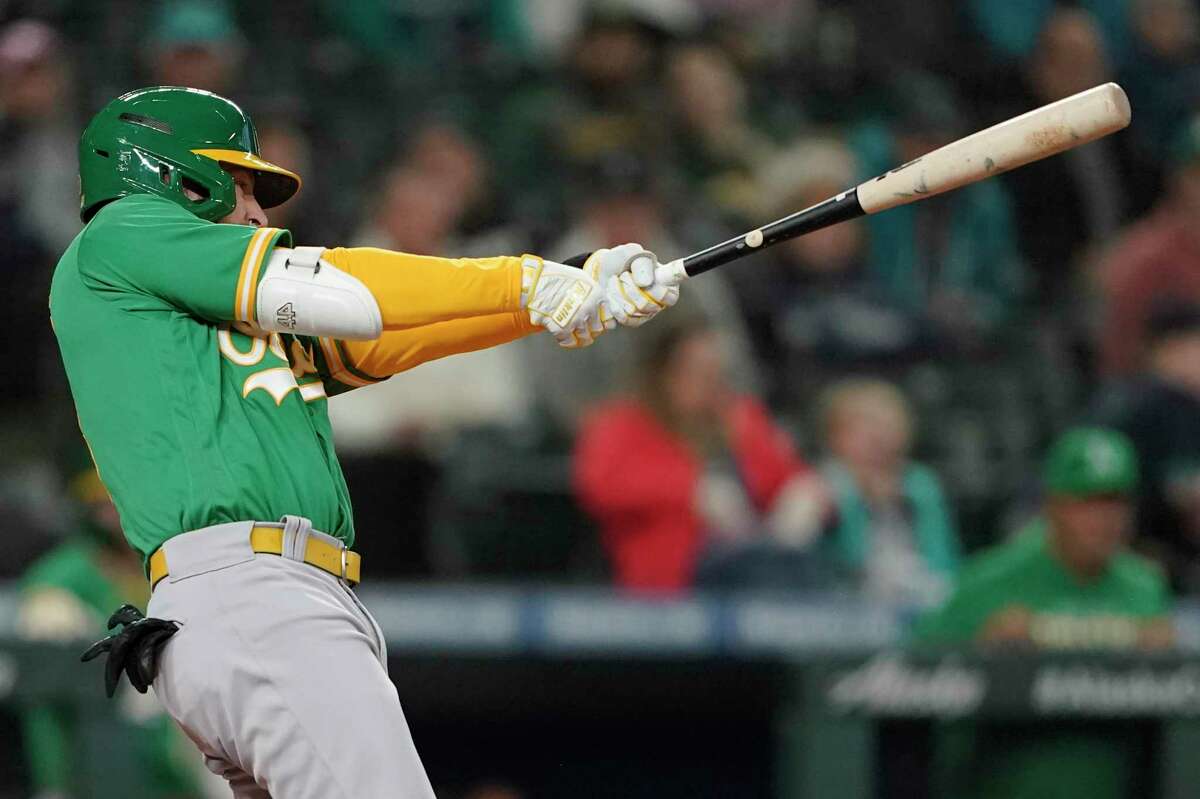 Oakland Athletics' Jed Lowrie follows through after hitting a two-run home run during the fifth inning of a baseball game against the Seattle Mariners, Tuesday, May 24, 2022, in Seattle. (AP Photo/Ted S. Warren)