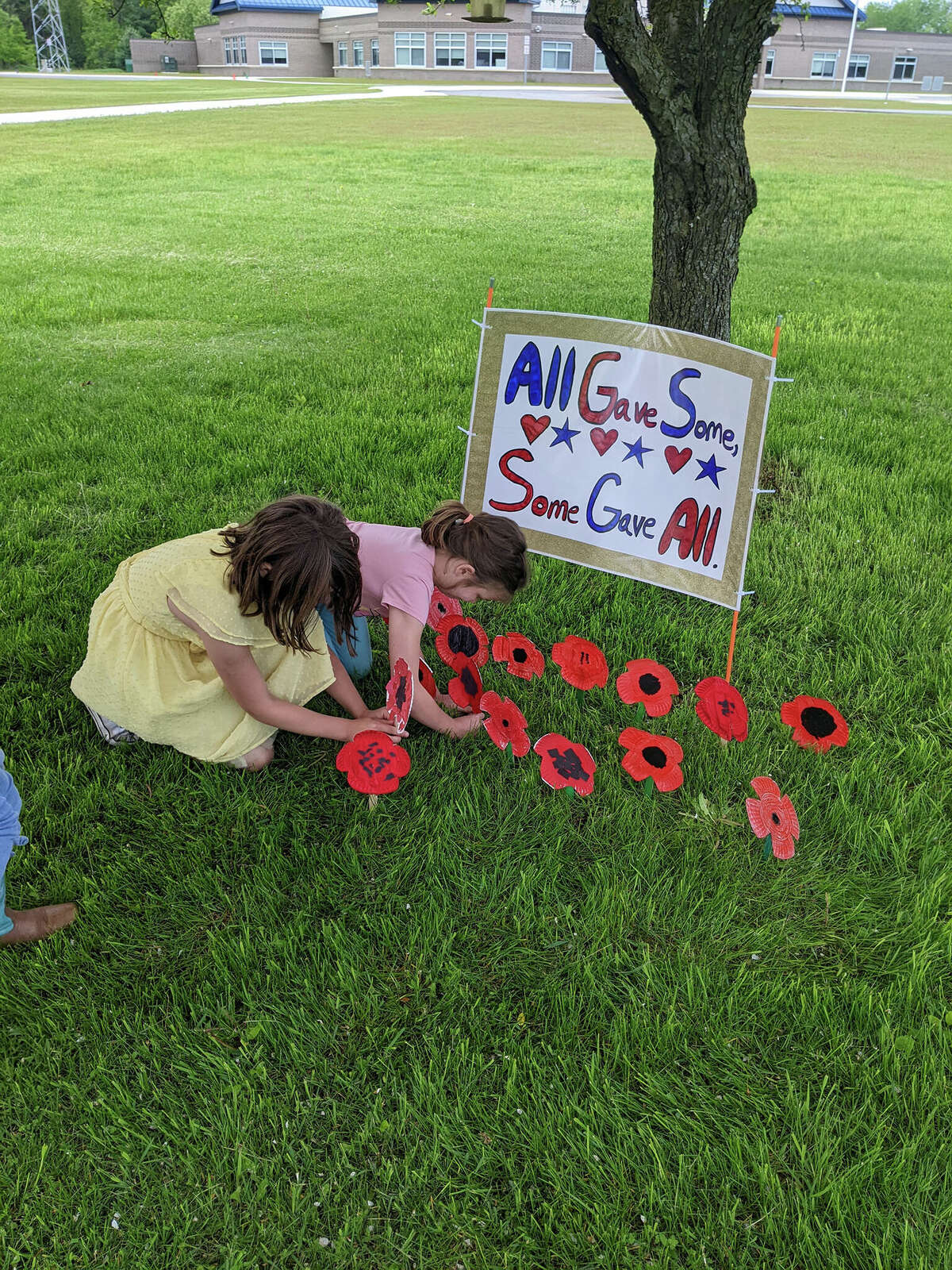 Students from Barryton Elementary spent place handmade poppies on graves of service members at local cemeteries and in front of the American Legion for Memorial Day.