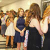 Students wait in a hallway for the start of Winchester Elementary School's promotion ceremony. The event marks the transition of eight-grade students to high schoolers.