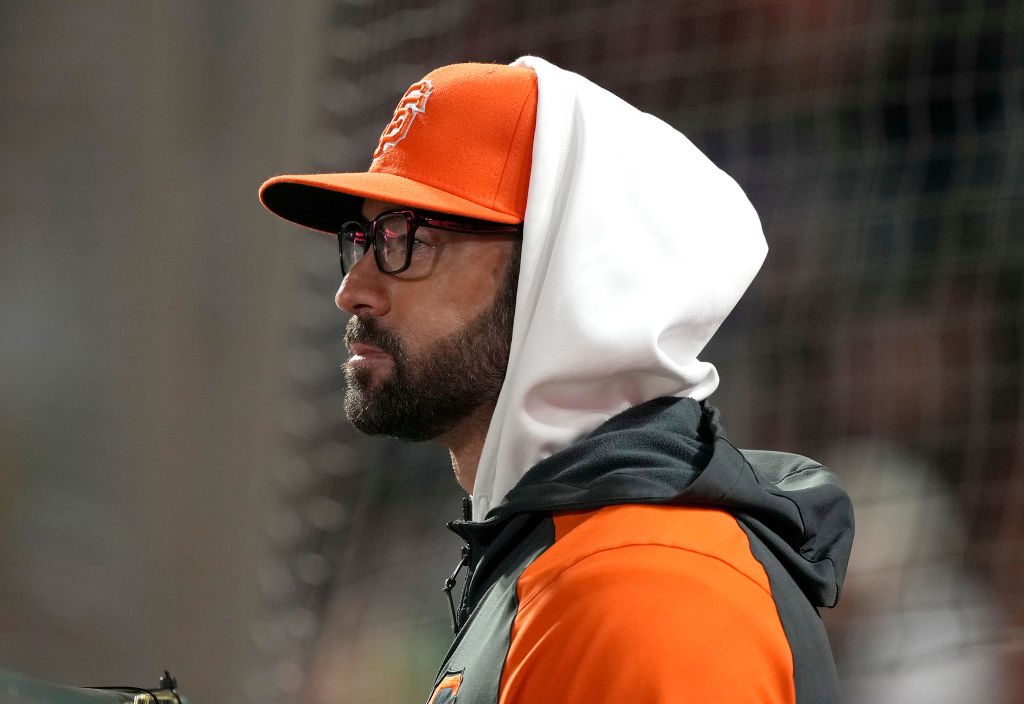 Giants Jewish manager Gabe Kapler kneels during playing of