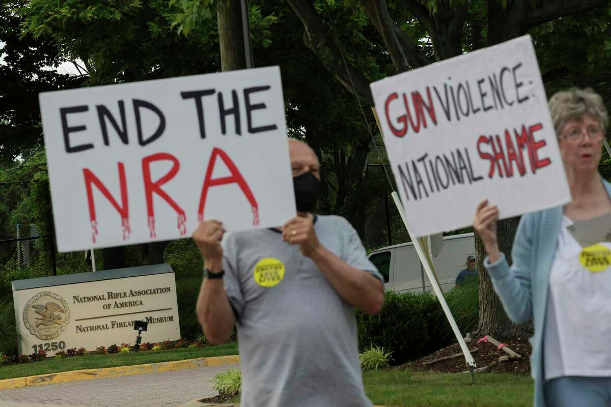 Gun-control advocates hold a vigil outside of the National Rifle Association (NRA) headquarters in Fairfax, Virginia. The group is calling for gun law reforms after an 18-year-old gunman killed 19 children and two teachers in Uvalde, Texas.