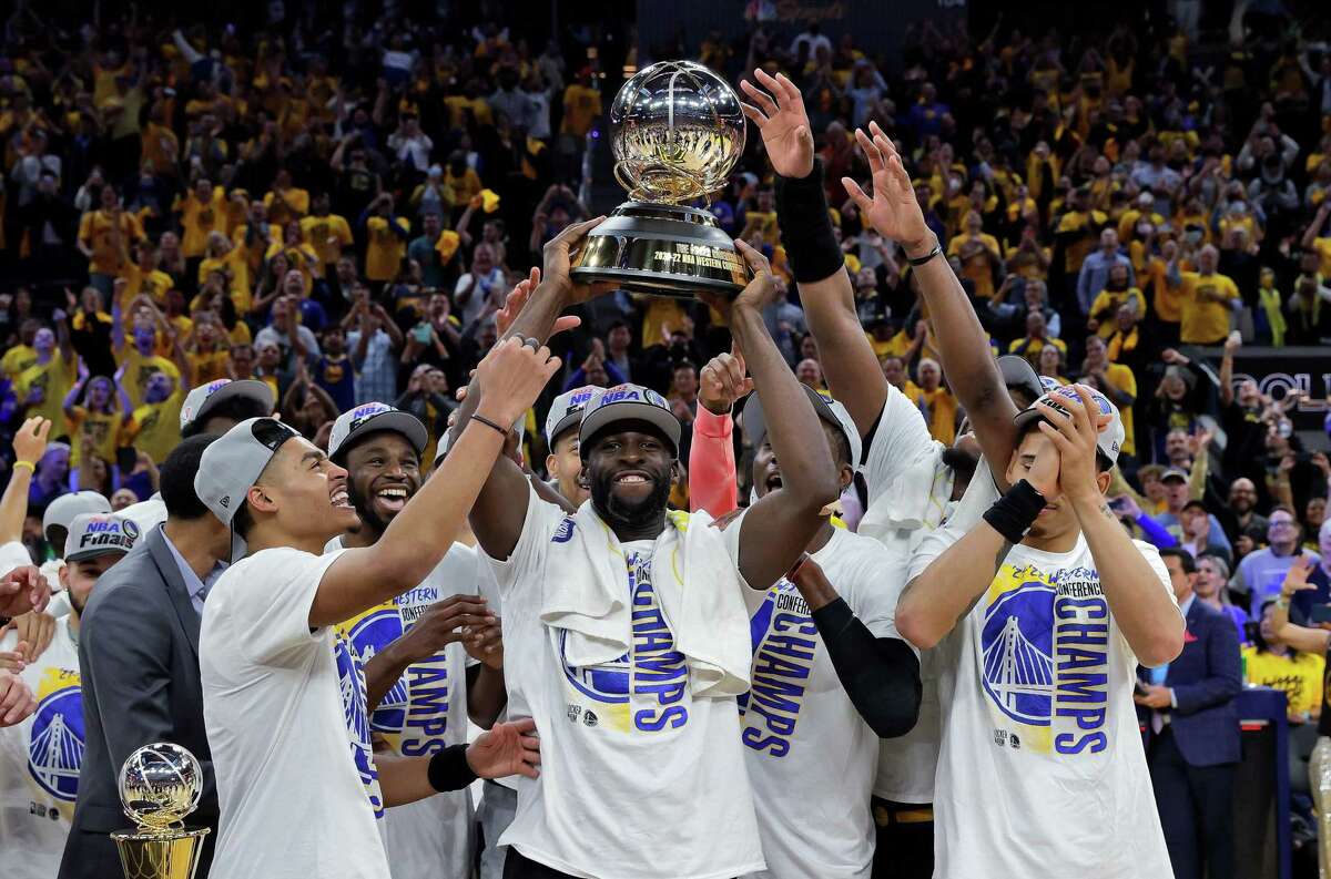 Draymond Green (23) lifts the Oscar Robertson Western Conference Championship Trophy after the Golden State Warriors defeated the Dallas Mavericks 120-110 at Chase Center in San Francisco in Game 5 of the Western Conference finals to advance to the NBA Finals.