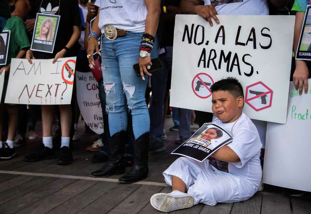 Children hold signs and photos of mass shooting victims, including a photo of Amerie Jo Garza, 10, who was fatally shot in Uvalde. The children are part of a protest rally against the presence of an NRA convention at the George R. Brown Convention Center in Houston, Friday, May 27, 2022.