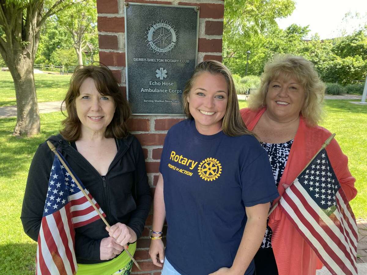 Derby-Shelton Rotary Club members Rosemary Allen, left, Julie Blakeman, center, and Linda Holmes-Hannon prepare for opening of the club's Flags for Heroes project to be displayed at Veteran's Memorial Park beginning Saturday, May 28, 2022.