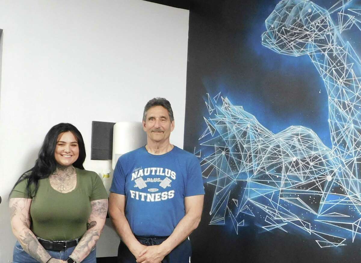 Colebrook residents Marina Diaz, left, and her partner, Jason Mikolajcik, have created an indoor mural project for Nautilus Fitness Plus co-owner Bruce "Coach" Kasenetz.