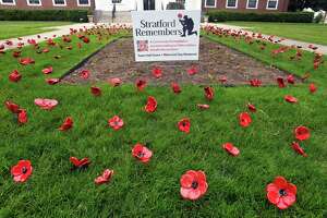 Stratford volunteers place 1,500 ceramic poppies for Memorial Day