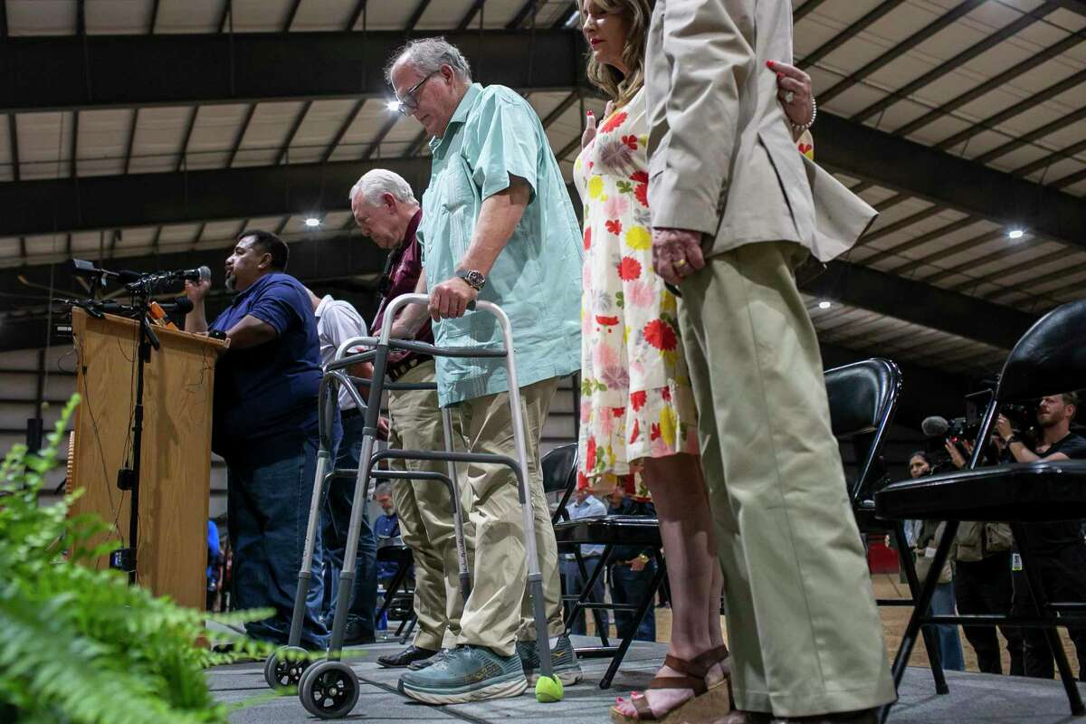 Uvalde Mayor Don McLaughlin stands as he prays during a vigil held in honor of the lives lost at Robb Elementary the day before at the Uvalde County Fairplex Arena in Uvalde, Texas, on May 25, 2022.