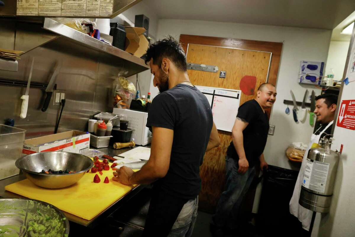Cooks Agustin Mora Chavarria (left), Oscar Duran and Marvin Gutierrez work in the kitchen at Breakers Cafe in Stinson Beach. All three live in San Rafael and commute to Stinson Beach for work.