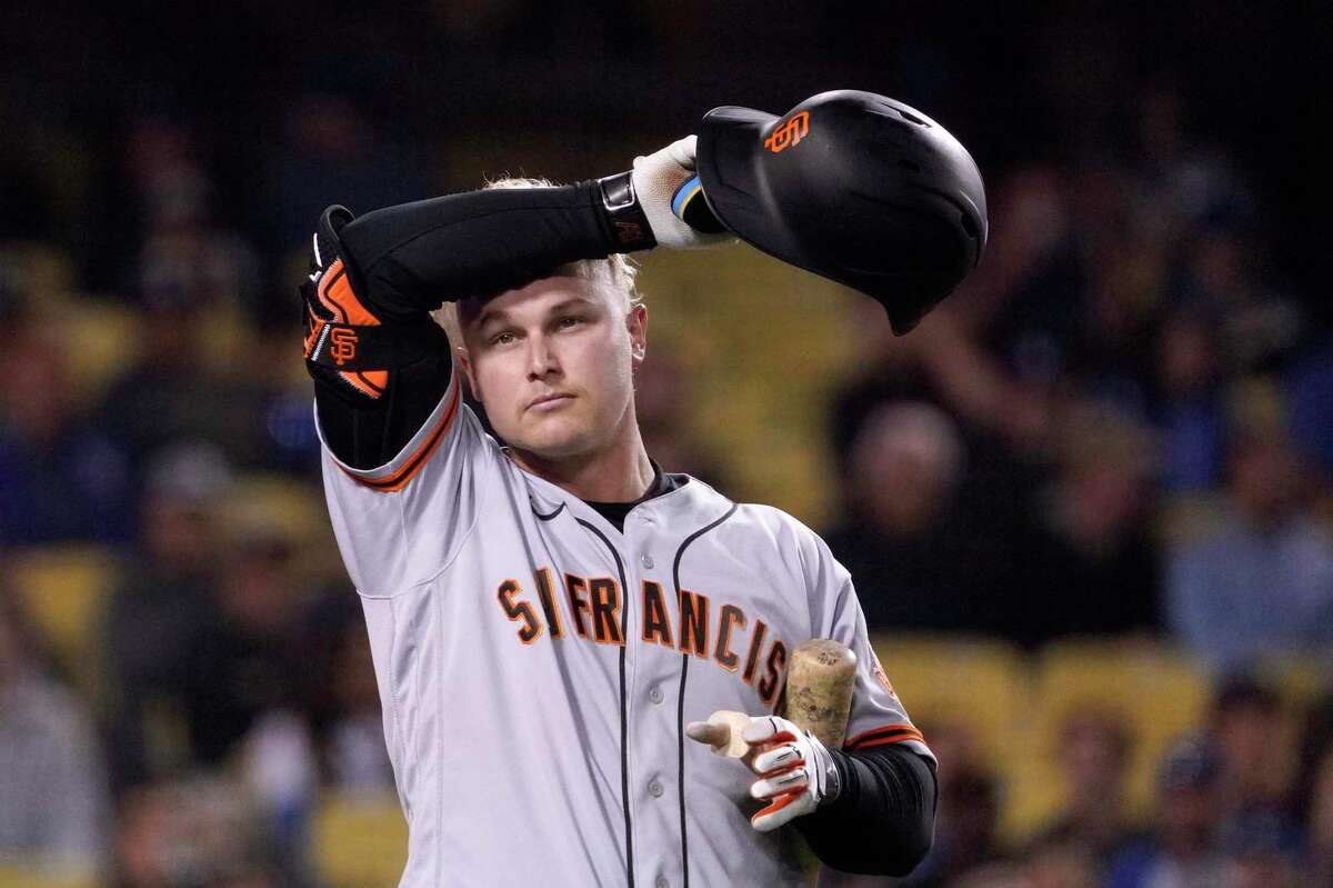 San Francisco Giants' Joc Pederson wipes his head as he bats during the eighth inning of a baseball game against the Los Angeles Dodgers Tuesday, May 3, 2022, in Los Angeles. (AP Photo/Mark J. Terrill)