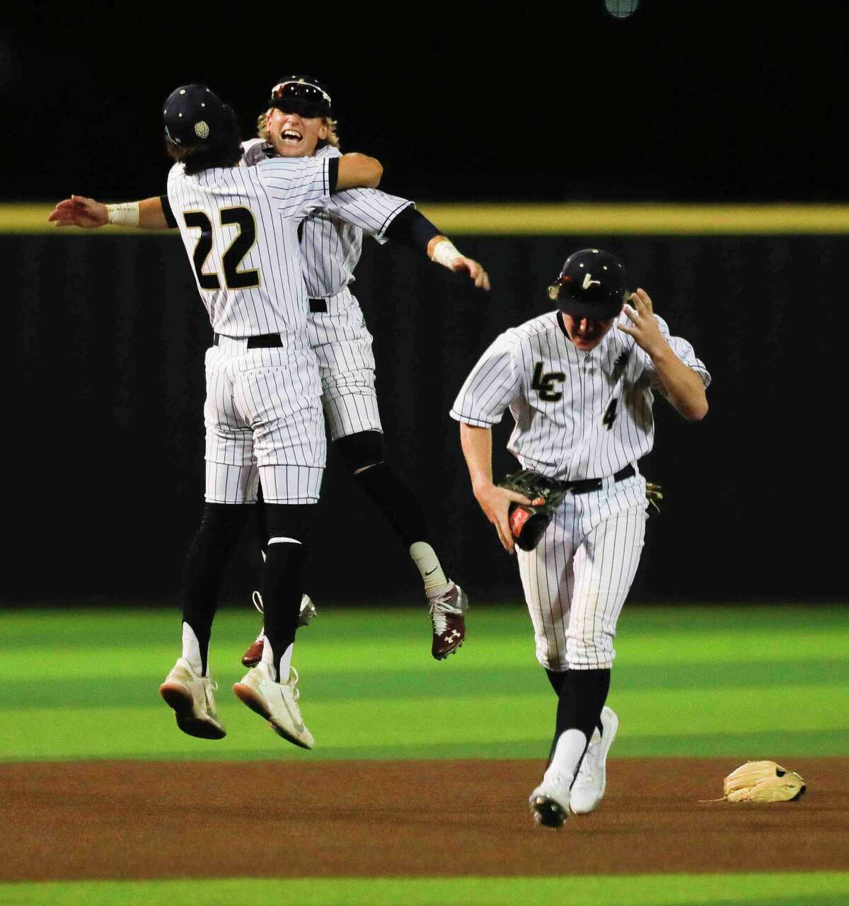 Lake Creek’s Jaron Lyness, center, and Jake Haag celebrate after the team’s 6-2 win over Milby in Game 2 of a Region III-5A semifinal high school baseball playoff series at Langham Creek High School, Friday, May 27, 2022, in Cypress.