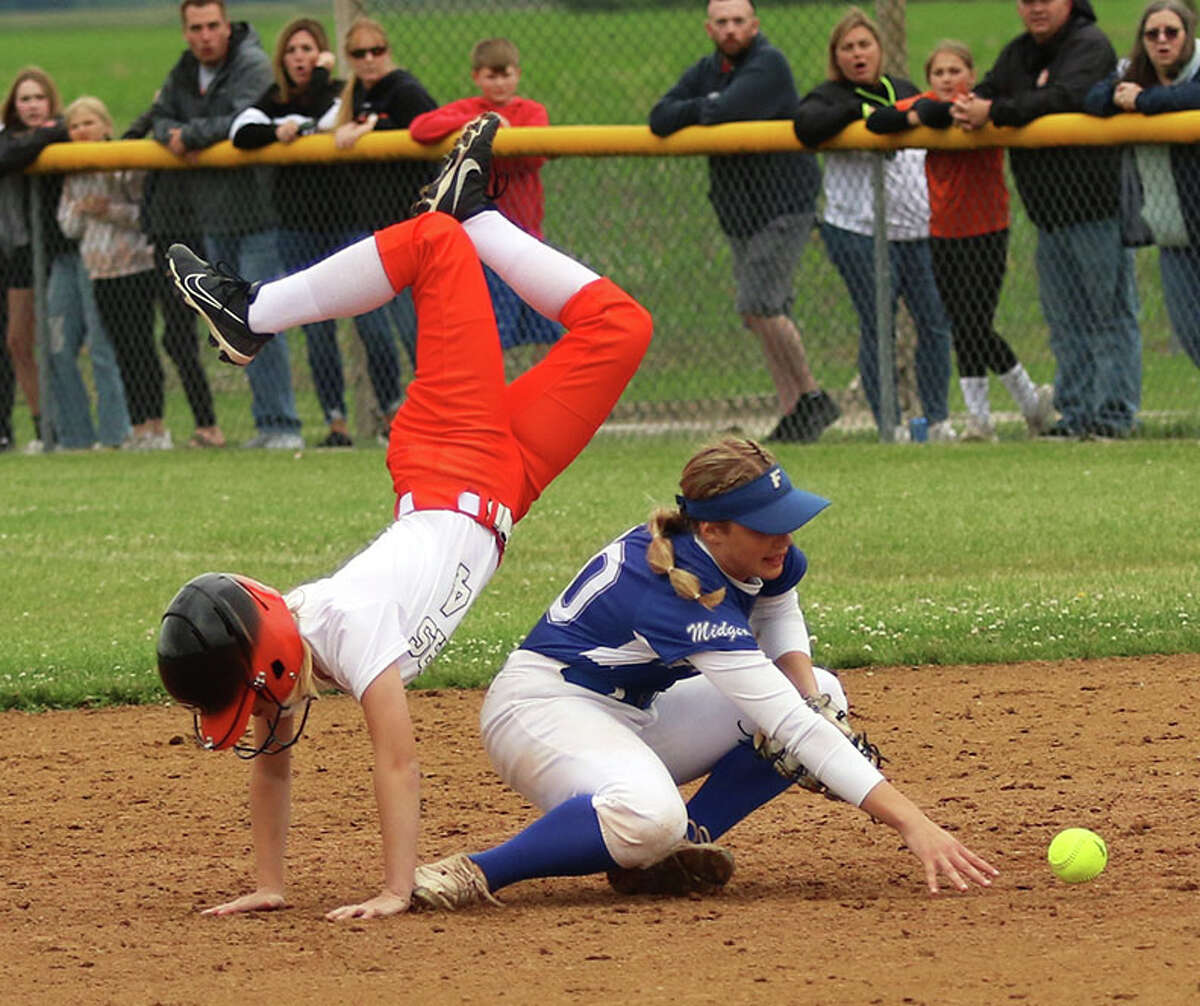 Gillespie courtesy runner Elissa Plasters Cline (left) does a handstand after flipping over Freeburg second baseman Maleah Blomenkamp on Friday in the title game of the Gillespie Class 2A Sectional. Plasters Cline was called out for runner's interference.