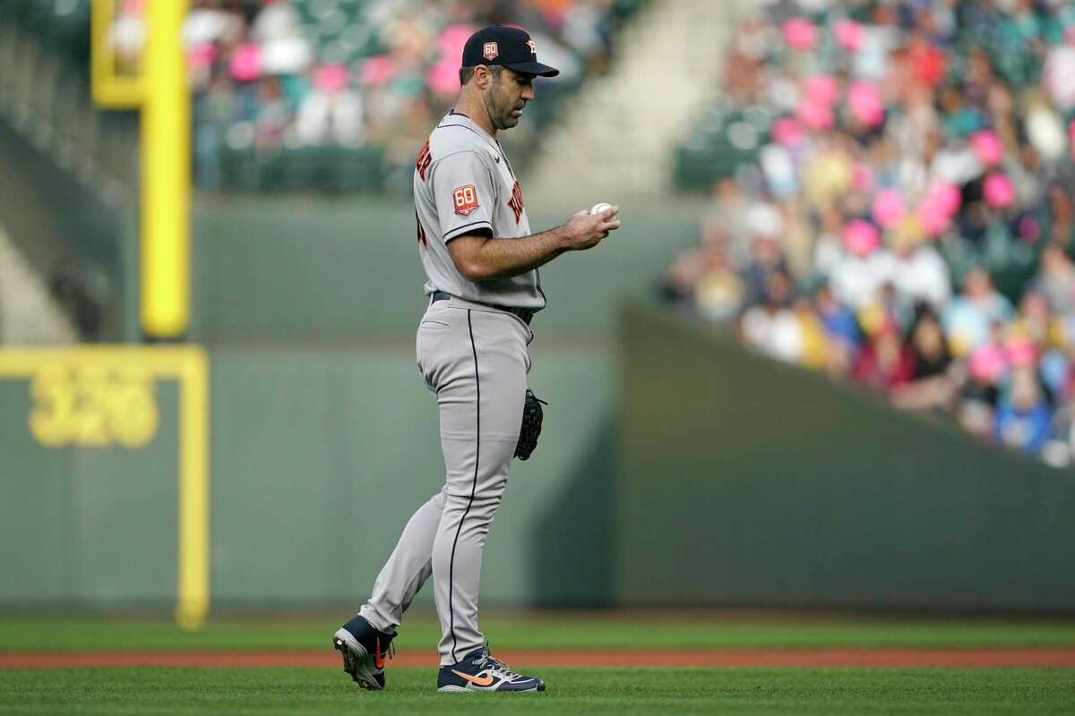 Houston Astros starting pitcher Justin Verlander holds the ball as he walks near the mound during the first inning of a baseball game against the Seattle Mariners, Friday, May 27, 2022, in Seattle. (AP Photo/Ted S. Warren)
