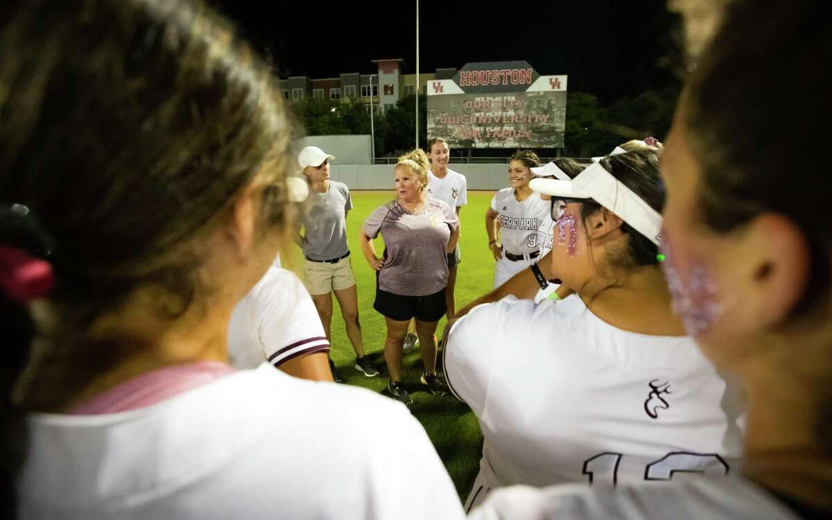 Deer Park head coach Amy Vidal-Bush speaks with her team on the field after defeating Perland 3-0 in Game 2 of the high school softball playoffs Region III-6A championship at Courgar Field, Friday, May 27, 2022, in Houston.