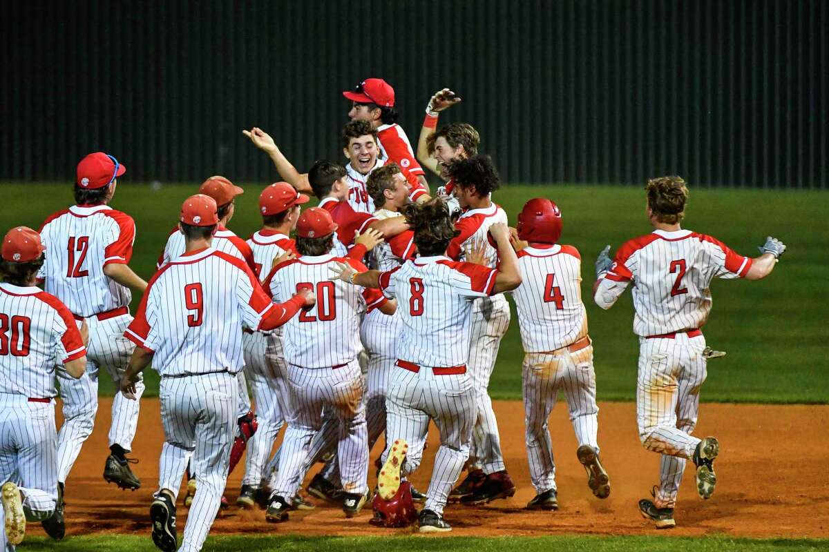 The Katy High School Tigers celebrate after defeating the Strake Jesuit Crusaders 3-2 in extra innings during game two of the 6A State Semifinals at Mayde Creek High School on May 27, 2022.`