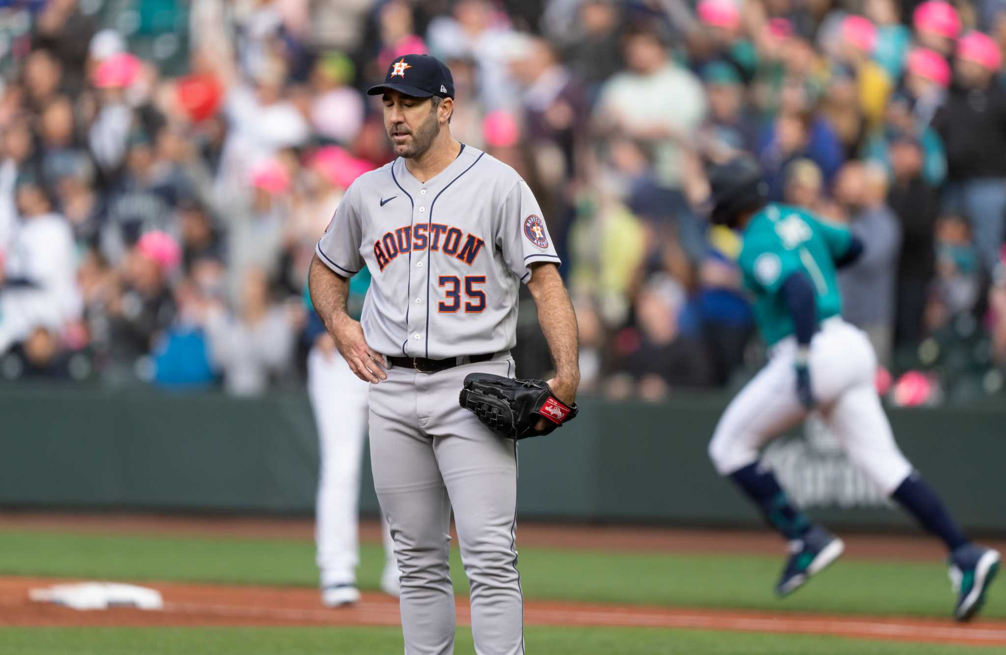 Seattle Mariners' Sam Haggerty is greeted in the dugout after