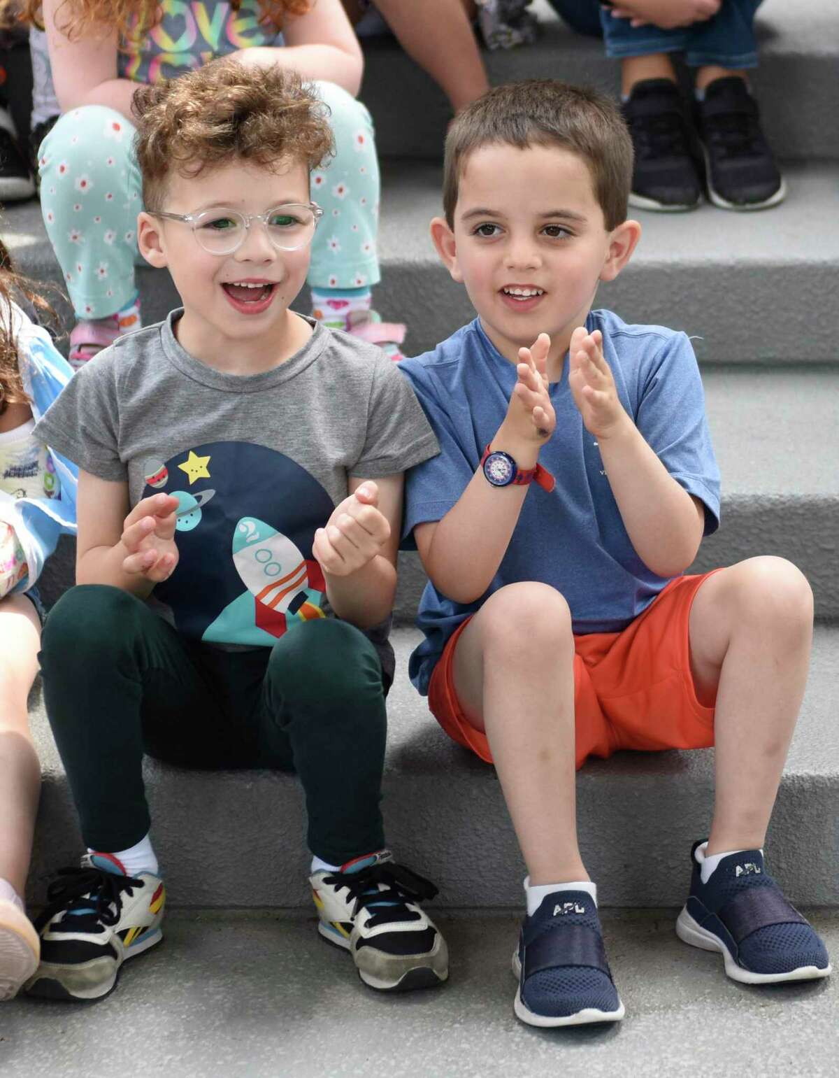 Selma Maisel Nursery School students Miles Tulchin, left, and Hunter Weiss clap during the Starfish Connection backpack donation event at Temple Sholom in Greenwich, Conn.  Thursday, May 26, 2022. 10 backpacks filled with essential materials were collected for the Stamford-based nonprofit Starfish Connection to be given to underserved students in grades five through 10 for an upcoming trip to High Rock Camp in the Berkshires.  Starfish Connection is an all-volunteer organization that seeks to close Stamford's academic achievement gap through mentoring, enrichment programs, and educational support.