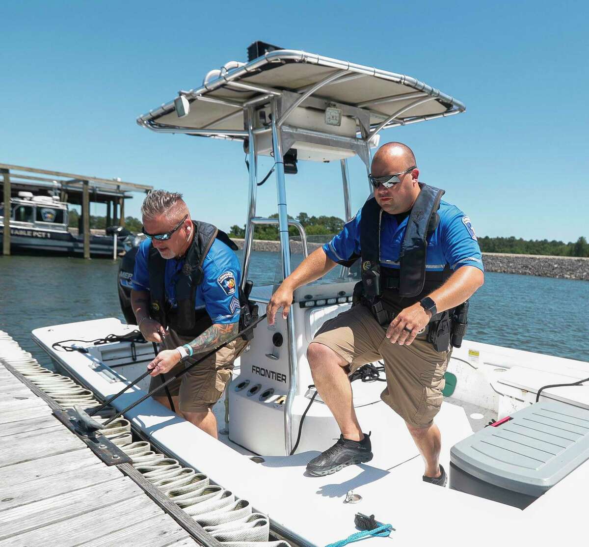 Lt. Miguel Rosario, with the Montgomery County Precinct 1 Constable’s marine division, (right) and Sgt. Travis Higginbotham dock their boat after patroling Lake Conroe, Thursday, May 26, 2022, in Conroe.