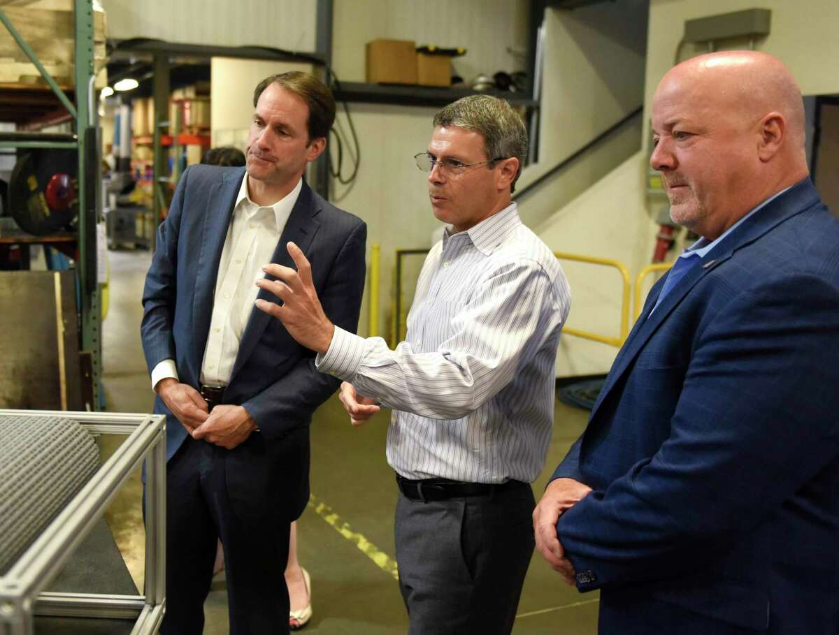 Goodway Technologies Executive Vice President of Engineering and Operations Greg Wyatt, center, and CEO Tim Kane, right, show a new steam cleaning machine to U.S. Rep. Jim Himes, D-Conn., at the Goodway Technologies headquarters in Stamford, Conn. Tuesday, May 24, 2022. Goodway was recently recognized by the Small Business Administration as an Exporter of the Year, and Congressman Himes stopped by Tuesday to congratulate the staff. Goodway participated in the SBA's STEP grant program and the Paycheck Protection Program.