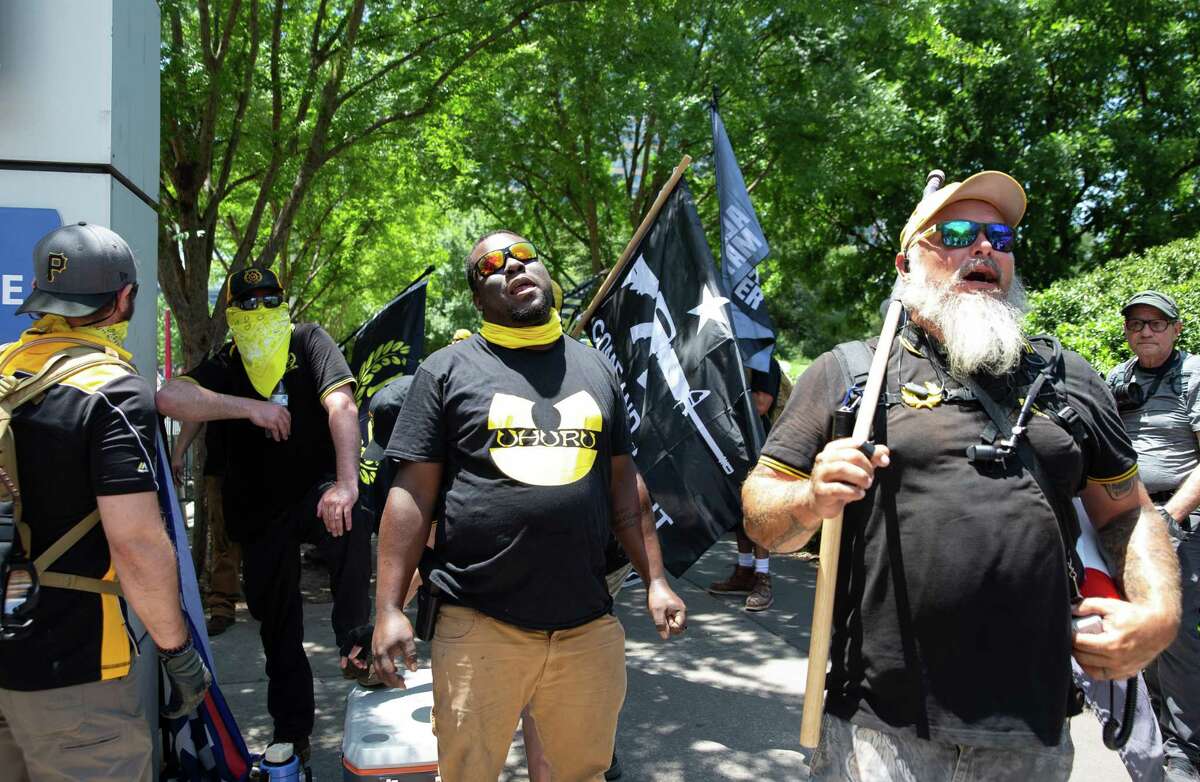 Proud Boys members show up and protest against a group of people protesting against the NRA convention taking place at the George R. Brown Convention Center Saturday, May 28, 2022, at Discovery Green in Houston.