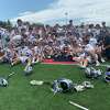 Members of the Darien boys lacrosse team celebrate after defeating Wilton, 12-6, to win the FCIAC championship Saturday at Casagrande Field in Norwalk.