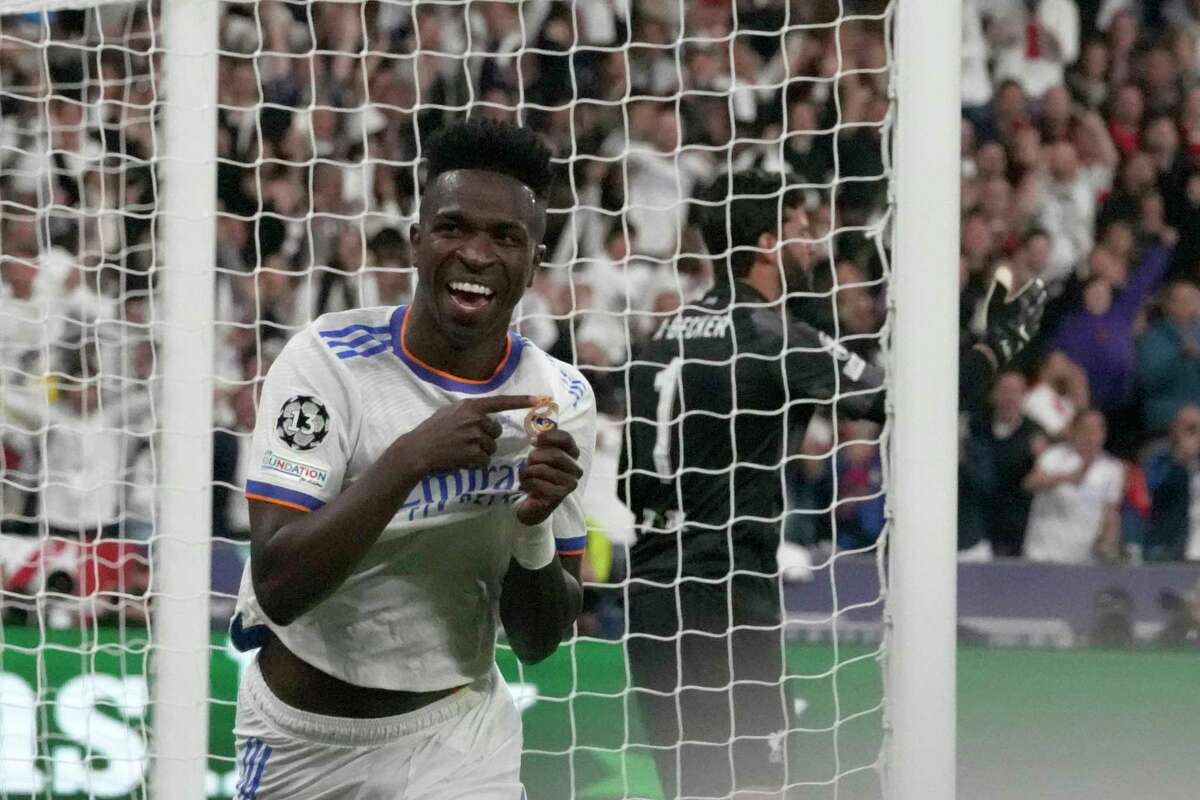 Real Madrid's Vinicius Junior celebrates after scoring his side's first goal during the Champions League final soccer match between Liverpool and Real Madrid at the Stade de France in Saint Denis near Paris, Saturday, May 28, 2022.