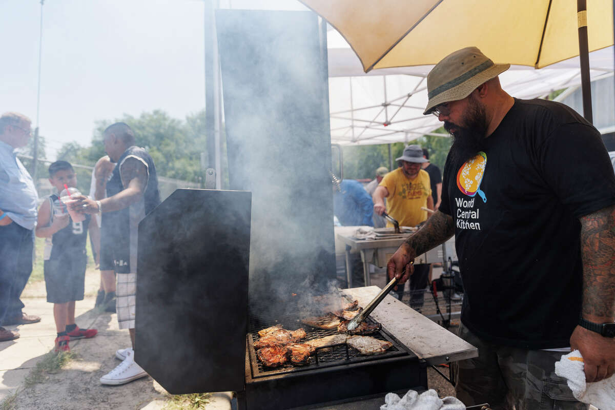 San Antonio chef Gabriel Ibarra grills pork chops to pair with potato hash and grilled jalapeÃ±os to give out to the Uvalde community for free in partnership with World Central Kitchen, an organization devoted to providing meals in the wake of disasters, on the corner of West Garden and South Getty Streets in Uvalde, Texas, Saturday, May 28, 2022. The Lawton Family of Restaurants group gave out 400 meals on Friday and 600 meals on Saturday.