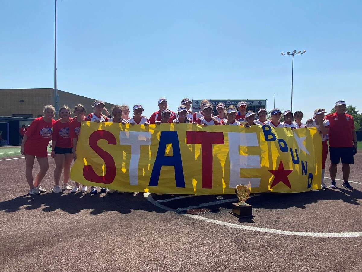 The Coahoma softball team holds a banner after beating Holliday 7-4 to sweep the Region I-3A Final and advance to the UIL state tournament. 
