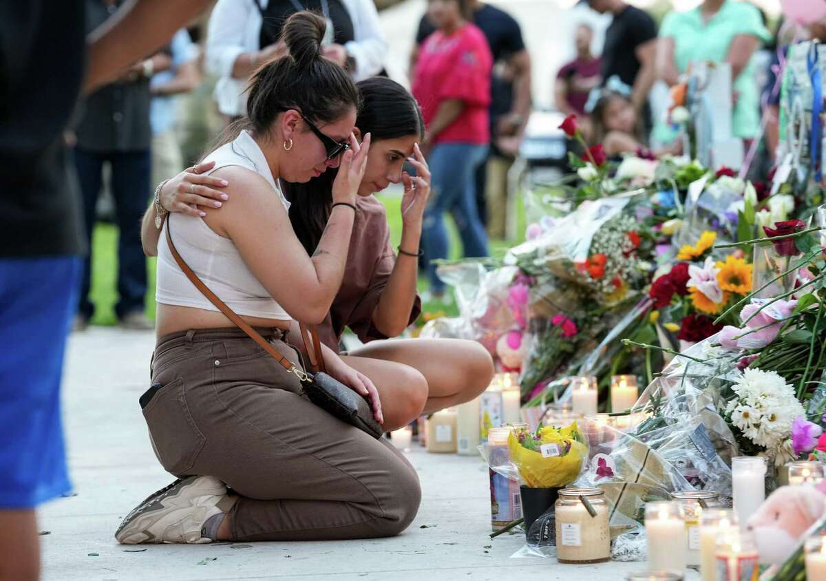 People visit the Town Square, the site of a memorial for the victims of the mass shooting at Robb Elementary School, on Friday, May 27, 2022, in Uvalde, Texas.