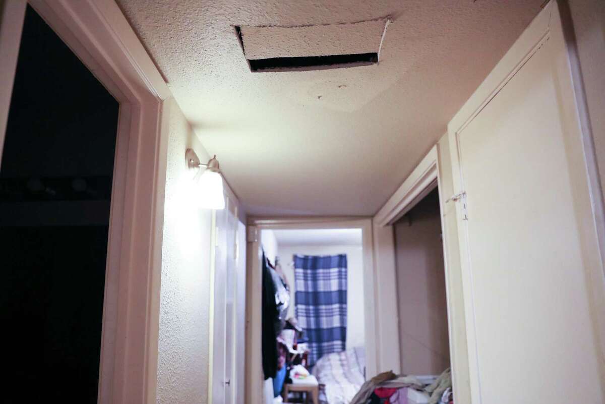 A hole was cut in the ceiling to relieve the moisture from the air conditioning condensation in the rental of Robia Massey and Dorran Gillespie pack up their home on Thursday, May 12, 2022 in Houston. The two thought they found the perfect home for their family in December, but after putting down the deposit and getting the keys, found out that the home was not available. They hastily rented an apartment that was in need of repairs, which they’ve tried to get the landlord to fix, but are now being evicted.